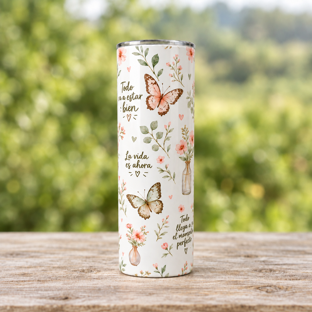 Segunda vista completa del vaso tumbler con mariposas sobre mesa de madera y fondo verde